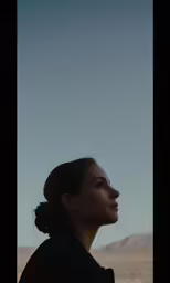 a woman standing and looking up into the sky