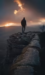 a person in the wilderness looking down at the sky and clouds