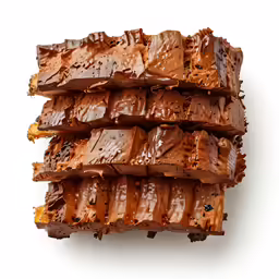 three blocks of chocolate in a pile on a white surface