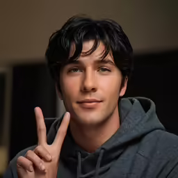 a man posing in front of a mirror giving a peace sign