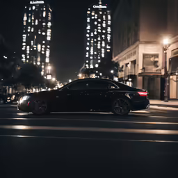a car parked on the street next to two skyscrapers