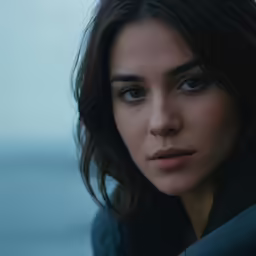 a woman looking down with very blue eyes