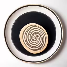 an abstract plate is displayed on a white surface