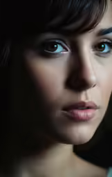 a woman wearing blue eyes with brown hair