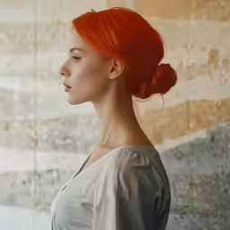 a woman with red hair is looking away from the camera
