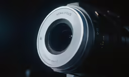a camera lens showing the light behind it