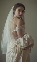 a bride holding her baby in her arms