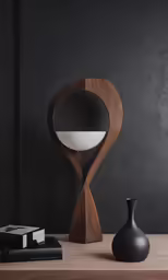 an object is sitting next to a vase on a table