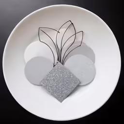 six round paper flowers in a white bowl