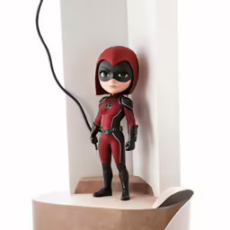 a little doll is standing next to a wall