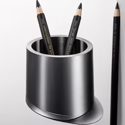 two pencils are placed inside the cup of an empty cup