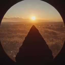 the view from the window shows a mountain and sky