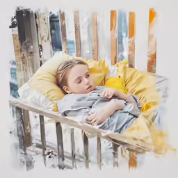 a child laying in a chair that looks like an outdoor bench