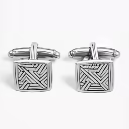 two cufflinks with an intricate design in sterling