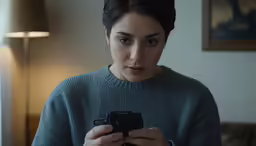 a woman using a smart phone in a room