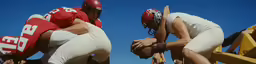 football players with helmets on bending over to squat
