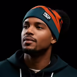 the man in a hat stares at the camera