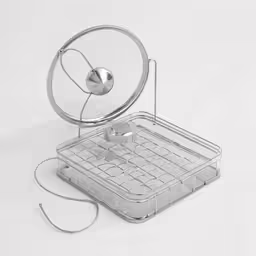 a silver object sitting on top of a white table