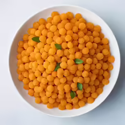 a white plate filled with food covered in cheese balls
