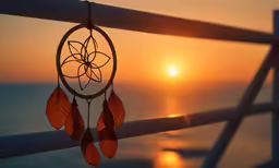 the sun is setting over the ocean with small beads in front of it