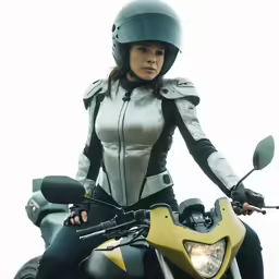 a woman wearing leather sitting on a motorcycle