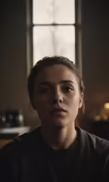 the young woman in black is staring into the camera