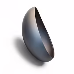 a black bowl with silver inside sitting on a table