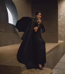woman in black standing on steps