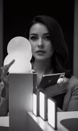 a woman is holding a small lit object in her hands