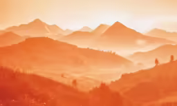 the beautiful mountain tops have a few trees on them