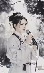 a woman in white holding an ornate microphone