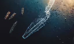 water drops on a body of water with boats in the water