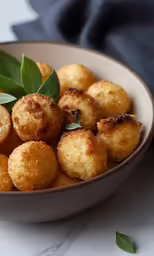 a white bowl with some small bites of food in it