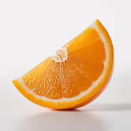 a very big bright orange slice sitting on the table