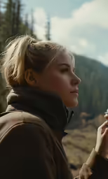 a woman in the outdoors is looking at something