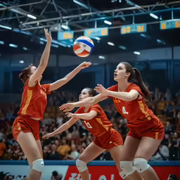 some girls are playing volleyball inside a gymnasium