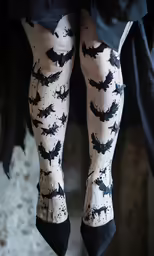 black and white cat patterned stockings on legs
