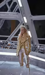 the blond haired lady is standing on a runway