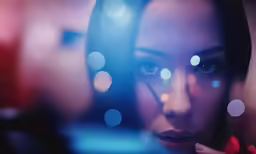 woman looking in mirror and looking into the camera