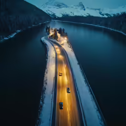 cars driving down the highway on a snowy night