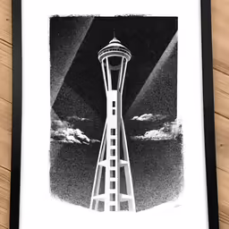 the framed artwork features a black and white photo of the space needle