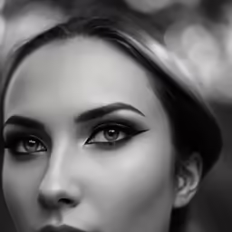 woman with big lashes looking at camera with intense look