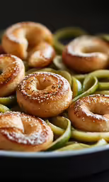 some small bagels with powdered sugar on them