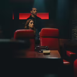 a man and a woman sitting in theater style seats