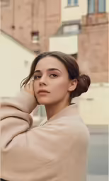 a beautiful woman sitting next to a street