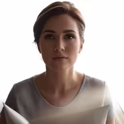 woman looks serious as she sits by the window
