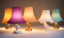 a number of lamps on a table with a dark background