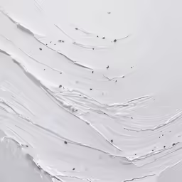 a snowboarder is riding through the snow, skiing