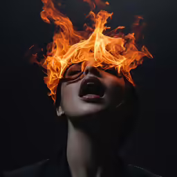 a woman with fire makeup on her face and a blaze in the mouth
