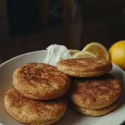 three pieces of cakes sit on top of one another on a white plate